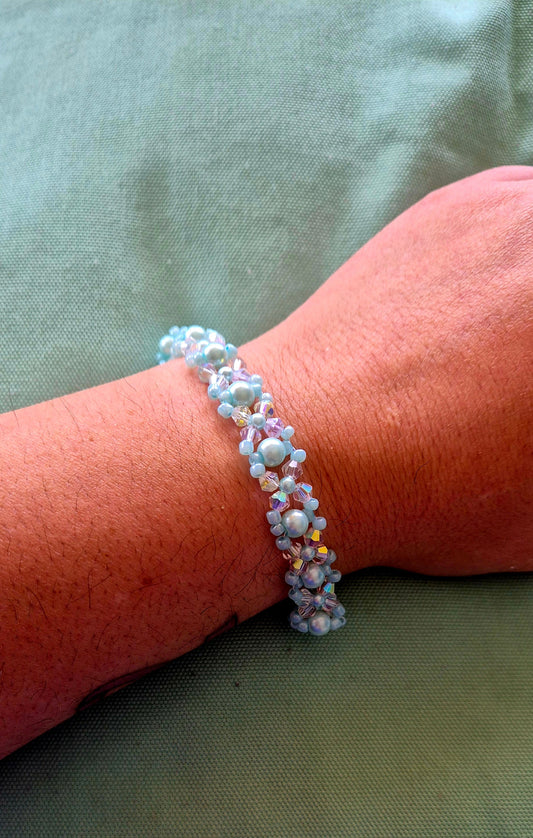 Mint blue pearl flower cluster bracelet worn on wrist